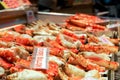 Many roasted king crab legs and claws with name and label price,