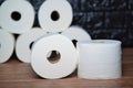 Many rolls of bathroom toilet paper on a wood and dark background Royalty Free Stock Photo