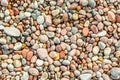 Many round and smooth colorful pebbles seen from above.