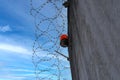 Many rows of barbedwire, high concrete fence, barbed wire fence on top, building for execution of punishments for criminals, Royalty Free Stock Photo