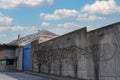 Many rows of barbedwire, high concrete fence, barbed wire fence on top, building for execution of punishments for criminals, Royalty Free Stock Photo