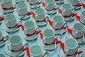 Many rows of pure white cup and saucer designed in vintage retro style. Note: the image contains grain as an element of