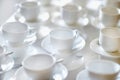 Many rows of pure white cups and saucers Royalty Free Stock Photo