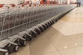 Many rows of red shopping carts outside by store with closeup by parking lot Royalty Free Stock Photo