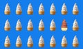 Many Rows of Two Types of Soft Serve Ice Cream Cones Isolated on Blue Background Royalty Free Stock Photo