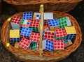 Many Rubik cubes stacked in a wicker basket.