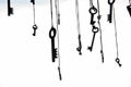 Many rustic keys hanging on string. Selective focus. Isolated