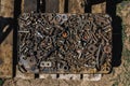 Many rusty bolts, nuts, washers, nails, spare parts in a metal box