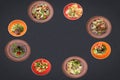 Many salads on a black background lie in a circle with sopy space