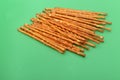 Many salted sticks over a green background Royalty Free Stock Photo