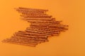 Many salted sticks over a orange background