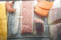 Many of Sashimi fresh food as squid and fish in Showcase at the bar counter of Sushi restaurant. Close up Royalty Free Stock Photo