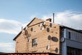 Many satellite dish antennas on the home wall. Brick house and satellite dishes in a small town Royalty Free Stock Photo