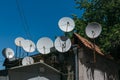 Many satellite dishes on the roof of the house. Royalty Free Stock Photo