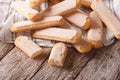 Many Savoiardi cookies closeup on a table. horizontal