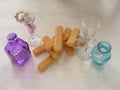 Many Savoiardi cookies closeup with violet and blue teal bottles and glass on a vintage white table.