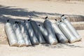 Many scuba diving air oxygen tanks cylinders at the beach Royalty Free Stock Photo