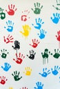 Hand prints in many colors on a white wall Royalty Free Stock Photo