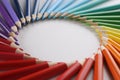 Many sharp multicolored sharp pencils lying in shape of circle closeup background Royalty Free Stock Photo