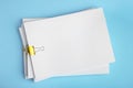 Many sheets of paper with golden clips on light blue background, top view Royalty Free Stock Photo