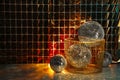 Many shiny disco balls on floor near foil party curtain. Space for text Royalty Free Stock Photo