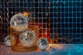 Many shiny disco balls on floor near foil party curtain. Space for text Royalty Free Stock Photo