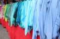 many shirts of many color for sale at market