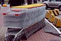 Many shopping carts for shopping are standing on the street near a busy intersection. Royalty Free Stock Photo