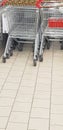 Many shopping carts stand in a row, Parking for carts in a supermarket, shopping and sale concept, copy space Royalty Free Stock Photo