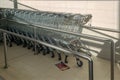 Many shopping carts in a supermarket. A lot of shopping wheel carts in a row Royalty Free Stock Photo