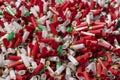 Many shotgun shells of various colors with empty fired cartridges , Can be used as a texture background