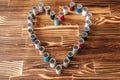 Many side by side aline thread spools in a heart shape on a wooden background. Royalty Free Stock Photo