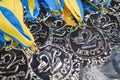 Many silver medals with blue ribbons on a silver tray