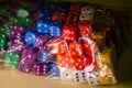 Six-sided dice of various colors in a plastic bag