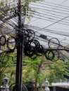 Many skeins of electric cables hang on a pole of power lines