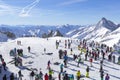 Many skiers and snowboarders stand on the slope before going down in the Austrian curort in Alps.Tirol. Royalty Free Stock Photo