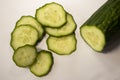 Many slice of green cucumber and a half piece are on white table, white background eight piece of scliced cucumber Royalty Free Stock Photo