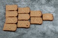 Many of slices of brown bread on a gray background Royalty Free Stock Photo