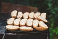 Many slices of roasted baguette bread on a grill over fire on fresh air Royalty Free Stock Photo