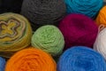 Many small balls of wool rainbowcolors on the wooden table. Royalty Free Stock Photo