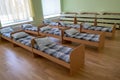 Many small beds in daycare preeschool empty bedroom Royalty Free Stock Photo