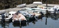 Small boats tied to dock and each other in Maine Royalty Free Stock Photo