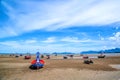 Many small fishing boats on sand beach during low tide with cloudy blue sky Royalty Free Stock Photo