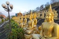 Many small,golden Buddha statues at Wat Phousalao,hilltop temple,reflecting sunset light,overlooking Mekong River,Pakse,southern Royalty Free Stock Photo