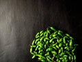 Many small green chillies isolated on black background Royalty Free Stock Photo