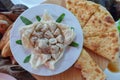 Many small khinkalis Georgian dumpling inside a one large khinkali on a white plate