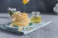 Many small pancakes with honey or syrup. Delicious traditional b Royalty Free Stock Photo