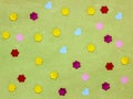 Many small paper hearts and flowers on green background Royalty Free Stock Photo