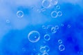 Many small soap bubbles rising against blue sky background Royalty Free Stock Photo