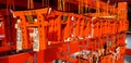 Many small Torii Gate hanging on red wooden hanger at Fushimi Inanari Shrine.